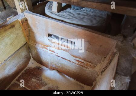 Traditional millstone for grinding grains at rustic mill . Stock Photo