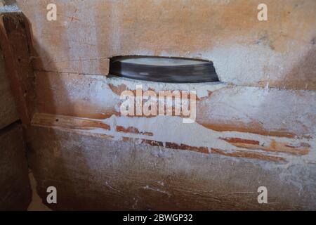 Closeup of traditional grinding grains at rustic mill . Stock Photo