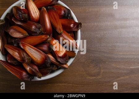 Bowl of pine nuts on the wooden table. Top View Stock Photo