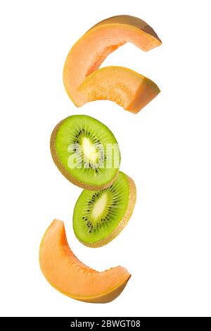 Flowing melon and kiwi fruits isolated on white background with shallow depth of field Stock Photo