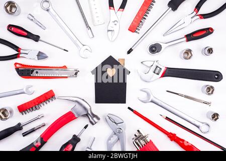 Repair tools as a foundation for a home on a light background Stock Photo