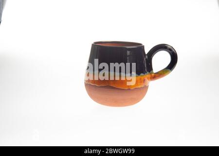 colorful handmade ceramic coffee cups on white background Stock Photo