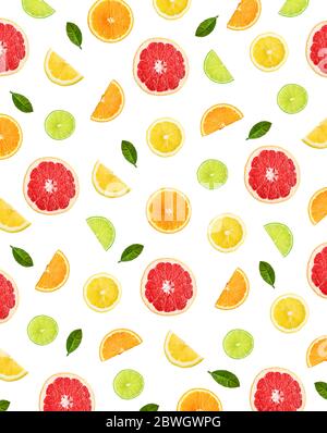 Colorful pattern of citrus fruit slices and citrus leaves isolated on white background. Top view, flat lay. Stock Photo
