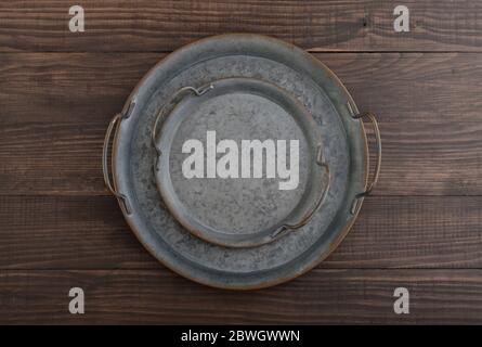 Vintage metal round tray on wooden background, top view Stock Photo