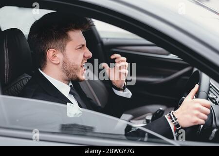 Angry business man driving in his new car Stock Photo