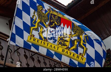 Bavarian flag waving in the wind - OBERAMMERGAU, GERMANY - MAY 27, 2020 Stock Photo