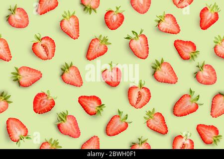 Strawberry slices as seamless pattern on green background Stock Photo