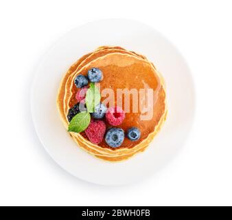 Pancakes with fresh berries and maple syrup on the  plate isolated on white background, top view Stock Photo