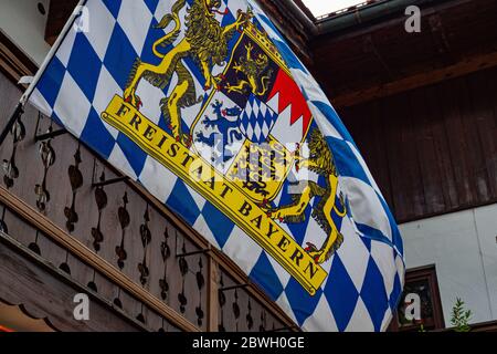 Bavarian flag waving in the wind - OBERAMMERGAU, GERMANY - MAY 27, 2020 Stock Photo