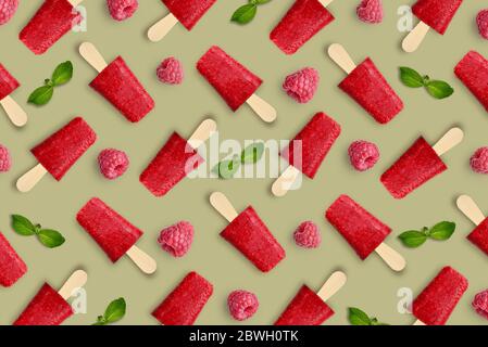 Pattern from raspberry popsicle on green background Stock Photo