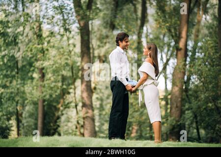 Wedding Couple Declaring Love Holding Hands Standing In Park Outdoor Stock Photo