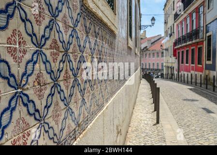 Traditional tile azulejos on the facade of the building in the  Alfama district in Lisbon, Portugal Stock Photo