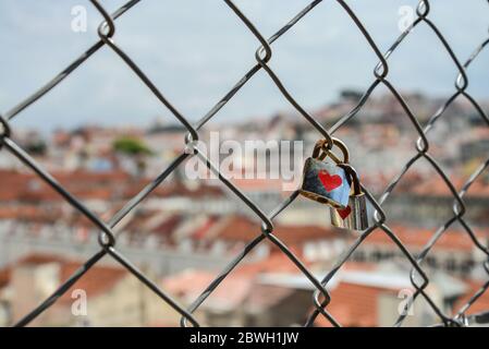 Locks on the fence of the bridge in lisbon as a symbol of eternal love