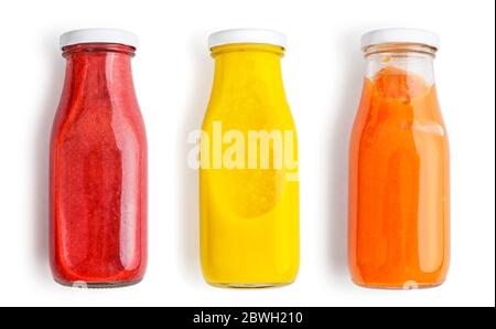 Fresh strawberry, mango and papaya smoothies in bottles isolated on white  background, top view. Stock Photo