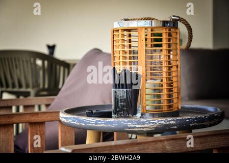Home decor wooden holder for candle on table with armcheirs in cafe interior Stock Photo