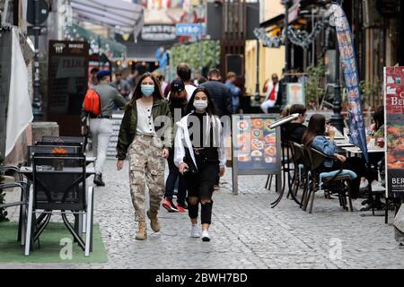 Bucharest, Romania. 1st June, 2020. People walk past reopened terraces of restaurants in Bucharest, Romania, on June 1, 2020. Romania adopted new relaxation measures from June 1, including reopening open-air terraces of restaurants and beaches, lifting the travel restrictions for residents, as well as allowing outdoor shows and sports events. Credit: Cristian Cristel/Xinhua/Alamy Live News Stock Photo