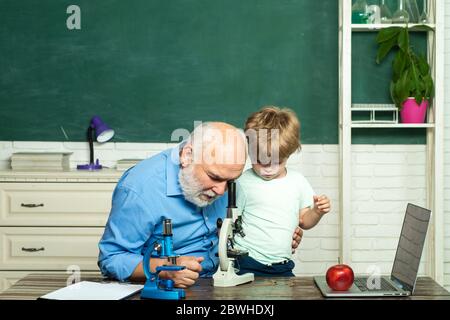 Concept of education and reading. Grandfather and grandson. Teacher is skilled leader. Thank You Teacher. Friendly child boy with old mature teacher Stock Photo