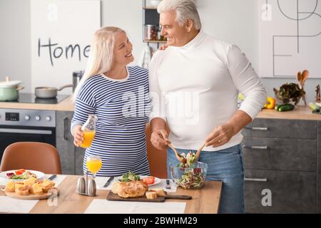 Happy elderly couple having breakfast at home Stock Photo