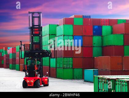 Container depot equipment, top lift inside yard with sunset sky background. Stock Photo