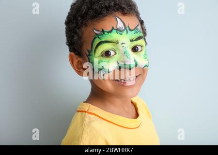 Funny African-American boy with face painting on color background Stock  Photo - Alamy