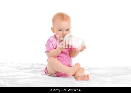 Cute little baby with bottle of milk on white background Stock Photo