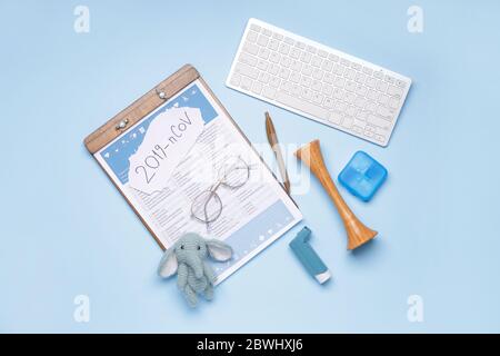 Laboratory test form, computer keyboard and toy on color background. Concept of coronavirus epidemic Stock Photo