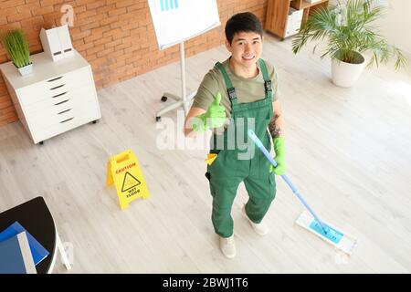 Portrait of male Asian janitor in office Stock Photo