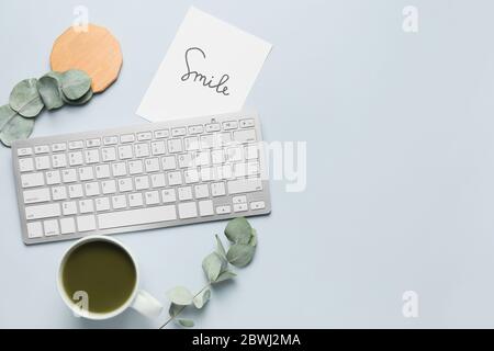 Computer keyboard with tea on light background Stock Photo
