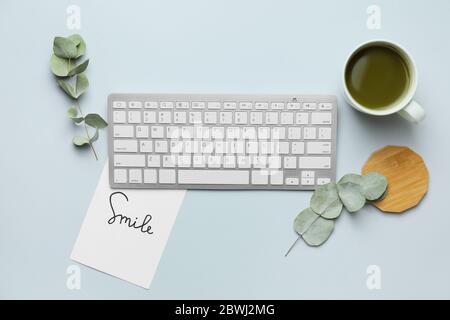 Computer keyboard with tea on light background Stock Photo
