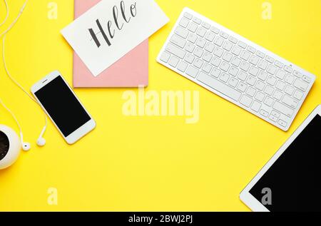 Computer keyboard with tablet PC, mobile phone and notebook on color background Stock Photo
