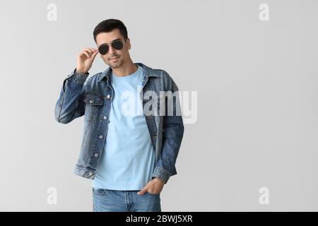 Man in stylish t-shirt on grey background Stock Photo