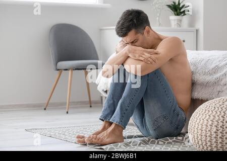 Young man suffering from anorexia at home Stock Photo