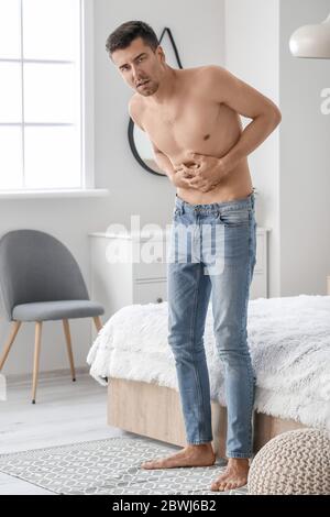 Young man suffering from anorexia at home Stock Photo