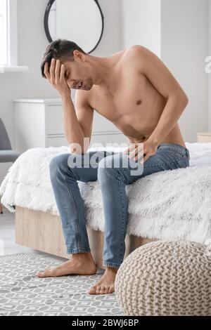 Young man suffering from anorexia at home Stock Photo