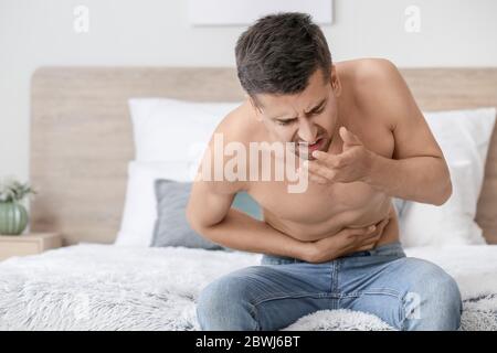 Young man suffering from anorexia at home Stock Photo