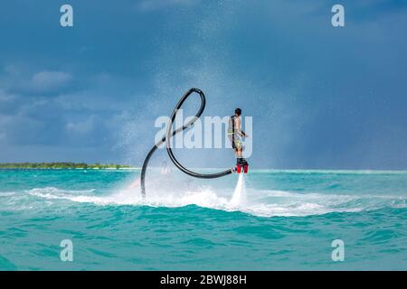Professional pro fly board rider in tropical sea, water sports concept background. Summer vacation fun outdoor sport. Stock Photo