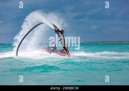 Professional pro fly board rider in tropical sea, water sports concept background. Summer vacation fun outdoor sport. Stock Photo