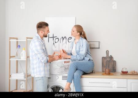 Happy couple doing laundry at home Stock Photo