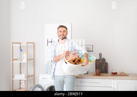 Young man doing laundry at home Stock Photo