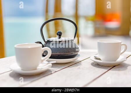 Asian tea set. Hot tea in pot and teacups. Japanese teapot and cups on  bamboo mat Stock Photo - Alamy