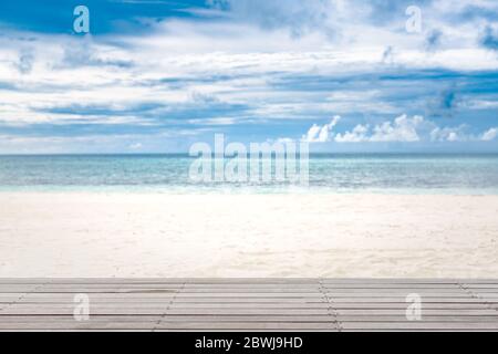 Empty white wood table top on blur abstract sea beach background with sunlight, for montage product display and mock up Stock Photo