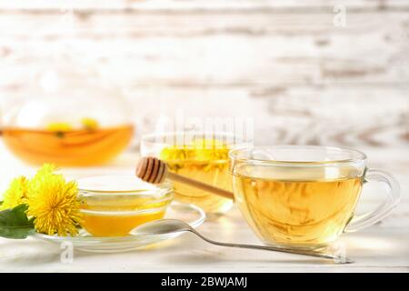 Healthy dandelion tea with honey on white wooden background Stock Photo