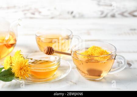 Healthy dandelion tea and honey on white wooden background Stock Photo