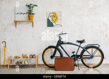 Stylish interior of modern hall with shoes on stand and bicycle Stock Photo