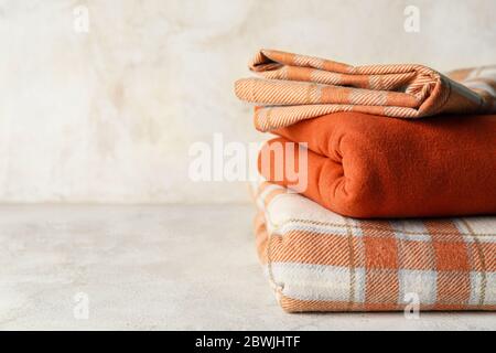 Stack of clean bed sheets on table Stock Photo
