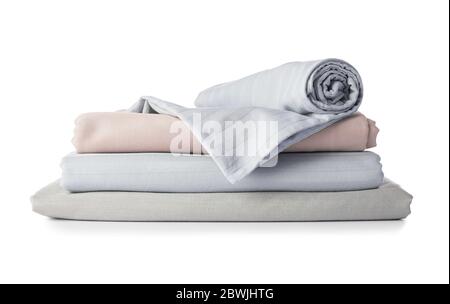 Stack of clean bed sheets on white background Stock Photo