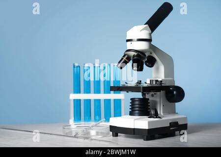 Modern microscope and test tubes on table in medical laboratory Stock ...