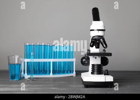 Modern microscope and test tubes on table in medical laboratory Stock ...