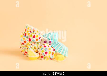 Muffin baking cups on color background Stock Photo