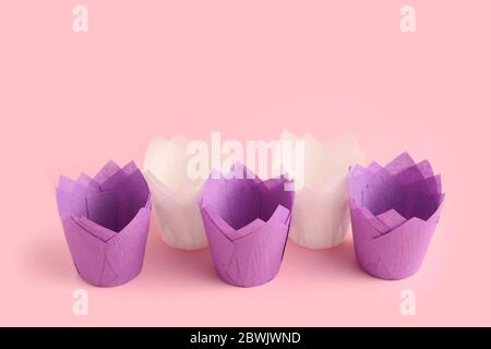 Muffin baking cups on color background Stock Photo